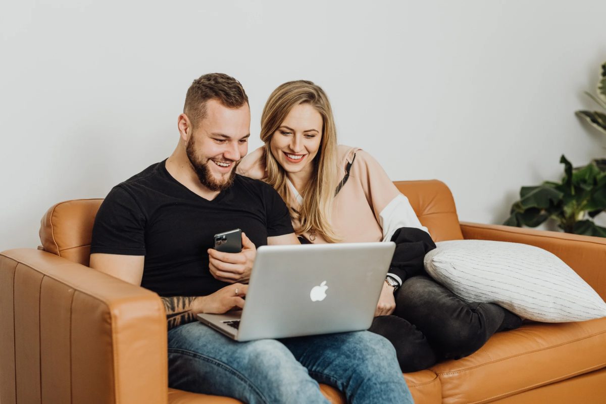 A couple reviewing their options together on a laptop at home